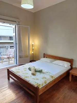 a bedroom with a bed with a stuffed animal on it at 5' απο μετρό, δωμάτιο με ιδιωτικό μπαλκόνι in Athens