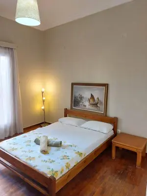 a bedroom with a bed with a stuffed animal on it at 5' απο μετρό, δωμάτιο με ιδιωτικό μπαλκόνι in Athens