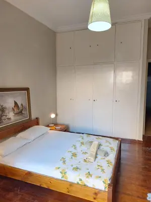 a bedroom with a bed with a phone on it at 5' απο μετρό, δωμάτιο με ιδιωτικό μπαλκόνι in Athens