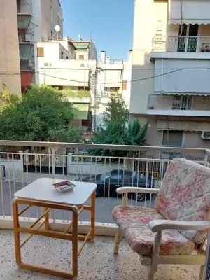 a balcony with a couch and a table and a chair at 5' απο μετρό, δωμάτιο με ιδιωτικό μπαλκόνι in Athens