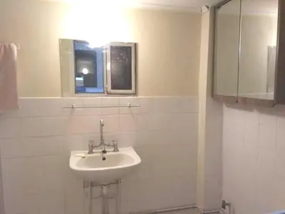 a white sink in a bathroom with a window at 5' απο μετρό, δωμάτιο με ιδιωτικό μπαλκόνι in Athens