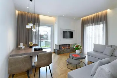 a living room with a couch and a table with chairs at Zana's cozy Apartment at Glifada in Athens