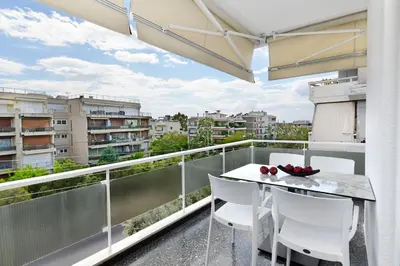 a balcony with a table and chairs and a view at Zana's cozy Apartment at Glifada in Athens