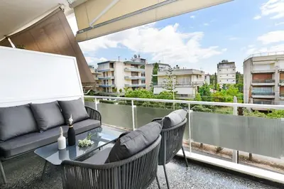 a balcony with a couch and chairs and a table at Zana's cozy Apartment at Glifada in Athens