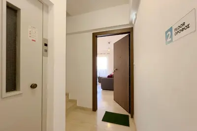 a hallway with a door leading to a living room at NAGIA Modern Apt Paleo Faliro B-1 in Athens
