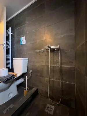 a bathroom with a shower and a toilet at NAGIA Modern Apt Paleo Faliro B-1 in Athens