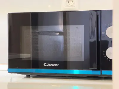 a microwave oven sitting on top of a counter at NAGIA Modern Apt Paleo Faliro B-1 in Athens