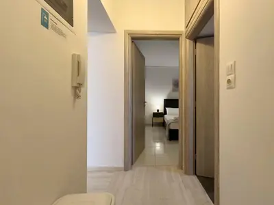 a hallway with a door leading to a bedroom at NAGIA Modern Apt Paleo Faliro B-1 in Athens