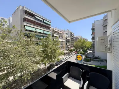 a balcony with chairs and a view of a street at NAGIA Modern Apt Paleo Faliro B-1 in Athens