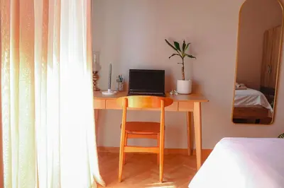 a desk with a laptop computer on it in a bedroom at Ampa's Home in Athens