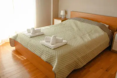 a bedroom with a bed with two towels on it at Ampa's Home in Athens