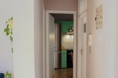 an open door to a kitchen with green cabinets at Ampa's Home in Athens