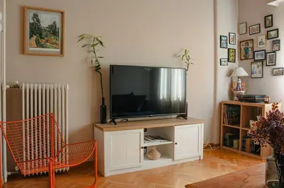 a living room with a flat screen tv on a cabinet at Ampa's Home in Athens