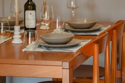 a wooden table with bowls and wine glasses on it at Ampa's Home in Athens