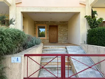 a house with a red gate and a door at Mesogaia Home Near ATH Airport in Markopoulo