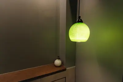 a green room with a light hanging from a wall at Livelula apartment in Athens