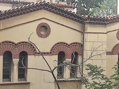 a building with two windows and a roof at Livelula apartment in Athens