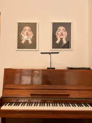 a piano sitting next to two pictures on a wall at Piano Quiet Apartment Garden in Athens