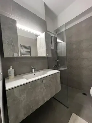 a bathroom with a sink and a mirror at Piano Quiet Apartment Garden in Athens