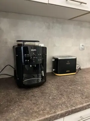 a coffee maker and toaster sitting on a kitchen counter at Piano Quiet Apartment Garden in Athens