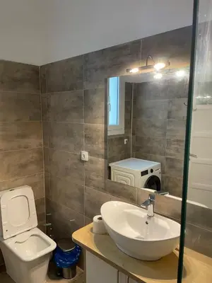 a bathroom with a sink and a toilet and a mirror at Quiet just renewed apartment in Neapolis in Athens
