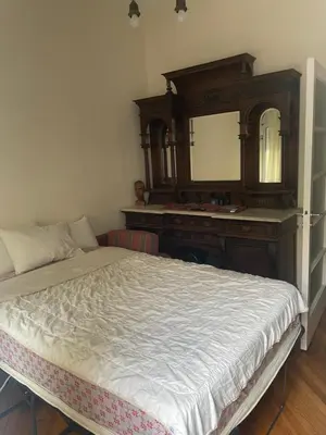 a bedroom with a bed and a dresser and a mirror at Quiet just renewed apartment in Neapolis in Athens