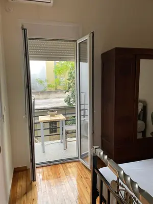a room with a sliding glass door leading to a patio at Quiet just renewed apartment in Neapolis in Athens