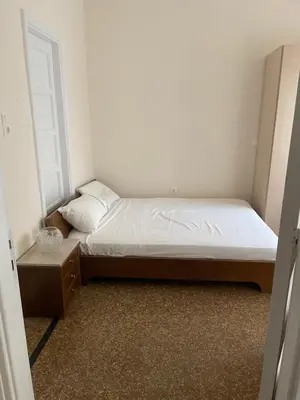 a small bedroom with a bed and a window at Quiet just renewed apartment in Neapolis in Athens