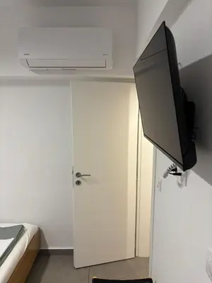 a flat screen tv on a wall in a room at TINY STUDIOS Under the Akropolis -2- in Athens