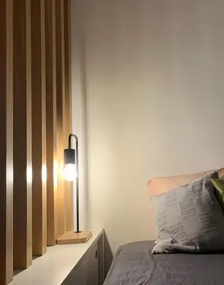 a bedroom with a bed and a lamp on a table at TINY STUDIOS Under the Akropolis -2- in Athens