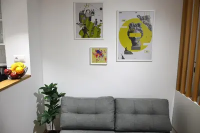 a living room with a couch and some pictures on the wall at TINY STUDIOS Under the Akropolis -2- in Athens