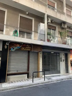 a building with a garage door and a balcony at TINY STUDIOS Under the Akropolis -2- in Athens