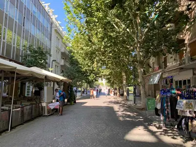 a street with shops and people walking down the street at TINY STUDIOS Under the Akropolis -2- in Athens