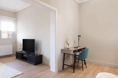 a living room with a desk and a tv at Beaming 2BR Apartment in Paleo Faliro by UPSTREET in Athens