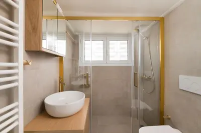 a bathroom with a shower and a toilet and a sink at Beaming 2BR Apartment in Paleo Faliro by UPSTREET in Athens