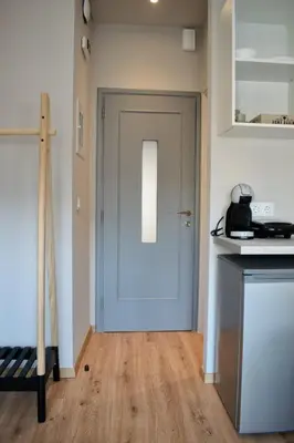 a room with a door and a kitchen with a counter at Gargaretta Suites Wildflower 1 Acropolis Museum District in Athens