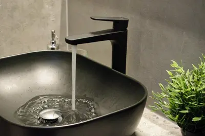 a black sink with water coming out of it at Gargaretta Suites Wildflower 1 Acropolis Museum District in Athens