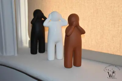 three figurines of people standing on a window sill at Gargaretta Suites Wildflower 1 Acropolis Museum District in Athens