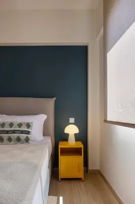 a bedroom with a bed and a lamp on a night stand at Athome Athens Luxury Flat in Athens