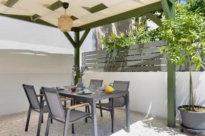 a table and chairs under an umbrella on a patio at Athome Athens Luxury Flat in Athens