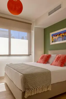 a bedroom with a large bed and a window at Athome Athens Luxury Flat in Athens