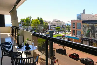 a balcony with a table and a view of a city at Glyfada Relax 9 in Athens