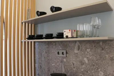 a shelf on a wall with glasses on it at Glyfada Relax 9 in Athens