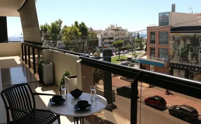 a balcony with a table and a view of a city at Glyfada Relax 9 in Athens
