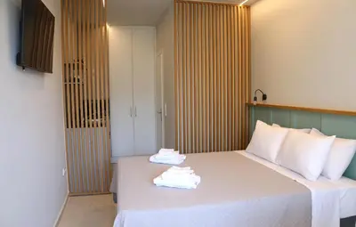 a hotel room with a bed with towels on it at Glyfada Relax 9 in Athens