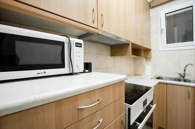 a kitchen with a microwave and a sink at Stylish And Comfortable Apartment in Athens