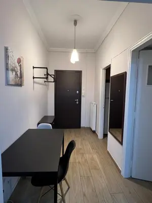 a living room with a table and a chair at Stylish And Comfortable Apartment in Athens