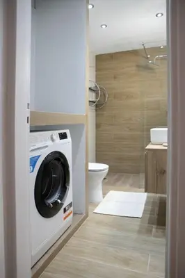 a washing machine in a bathroom with a toilet at Stylish And Comfortable Apartment in Athens
