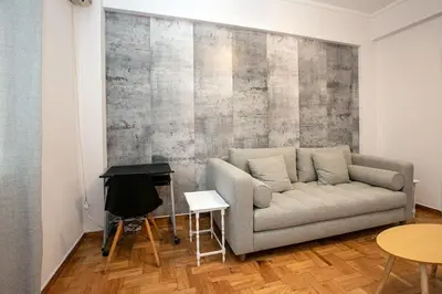 a living room with a couch and a table at Stylish And Comfortable Apartment in Athens