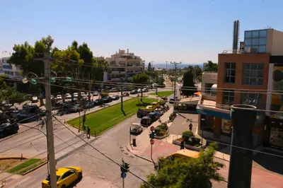a city street with a lot of parked cars at Glyfada Relax 8 in Athens